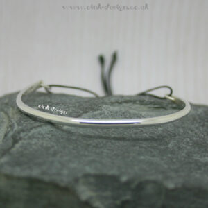Sterling silver bangle with adjustable cord